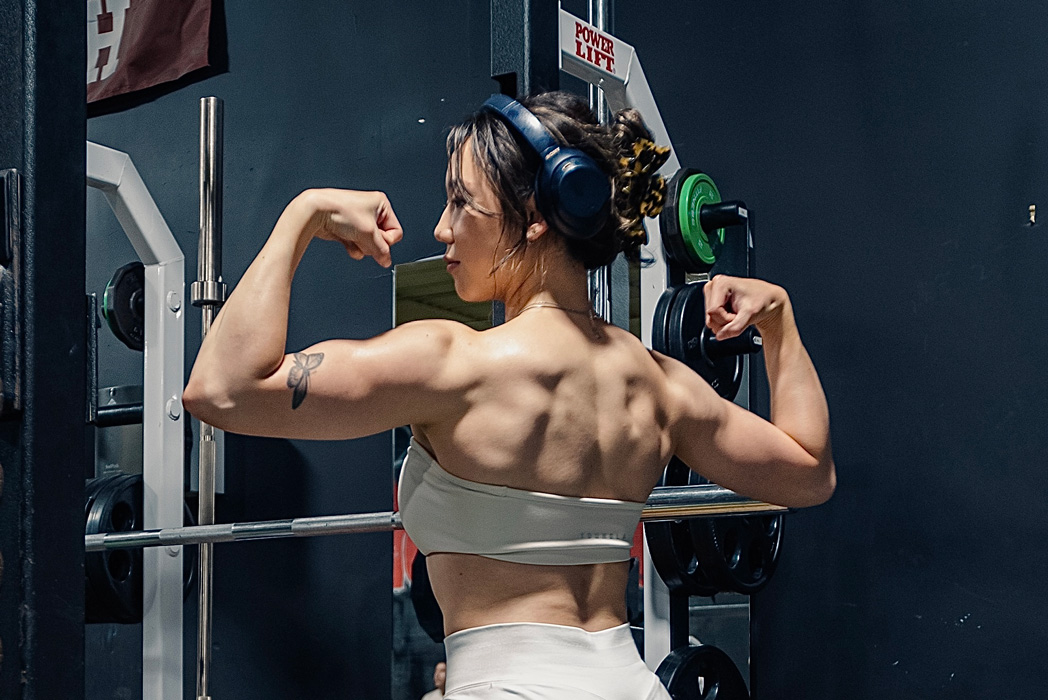 Coach posing in gym wear dress